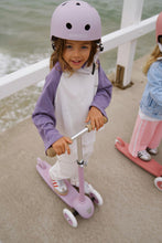 Load image into Gallery viewer, Child riding a Banwood Eco Scooter in Lavender during outdoor play.