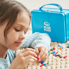 Load image into Gallery viewer, Child playing with colorful building blocks next to a blue Plus-Plus box.