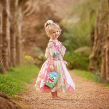 Load image into Gallery viewer, Tiger Tribe Forest Fairies Colouring Set – lifestyle shot of child holding colouring set outdoors – the outdoor kid.