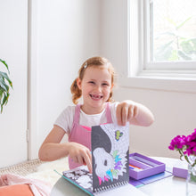 Load image into Gallery viewer, Tiger Tribe Colouring Set – Mystical Forest – lifestyle shot of child colouring – the outdoor kid.