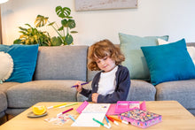 Load image into Gallery viewer, Tiger Tribe Magical Creatures Colouring Set – lifestyle shot of child colouring – the outdoor kid.