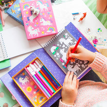 Load image into Gallery viewer, Tiger Tribe Unicorn Magic Colouring Set – lifestyle shot of child colouring – the outdoor kid.