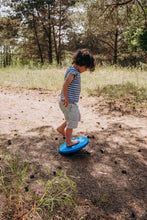 Load image into Gallery viewer, Child using the Stapelstein® Balance Board outdoors during playful balance exercises.