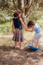 Load image into Gallery viewer, Children playing with Stapelstein® Balance Board outside, exploring movement and balance play.