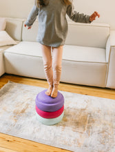 Load image into Gallery viewer, Child balancing on Stapelstein® Mint, Violet & Pink stacking stones indoors.