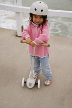 Load image into Gallery viewer, Child riding a Banwood Eco Scooter in Ivory during outdoor play.
