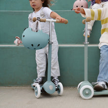Load image into Gallery viewer, Child riding a Banwood Eco Scooter in Teal during outdoor play.
