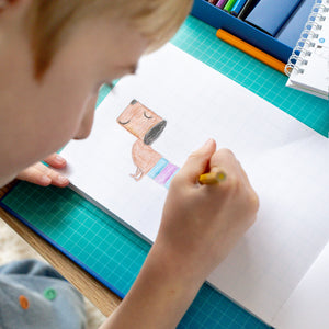 Tiger Tribe How to Draw – Dinosaurs – lifestyle shot of child drawing – the outdoor kid.