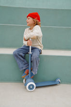 Load image into Gallery viewer, Child riding a Banwood Eco Scooter in Deep Sea during outdoor play.
