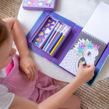 Load image into Gallery viewer, Tiger Tribe Colouring Set – Mystical Forest – lifestyle shot of child colouring – the outdoor kid.
