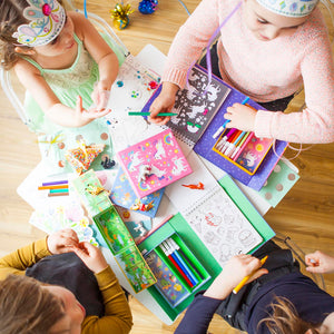Tiger Tribe Unicorn Magic Colouring Set – lifestyle shot of kids colouring – the outdoor kid.